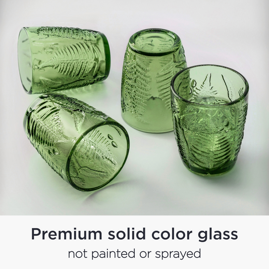 Set of four hand-blown green vintage drinking glasses with antique texture