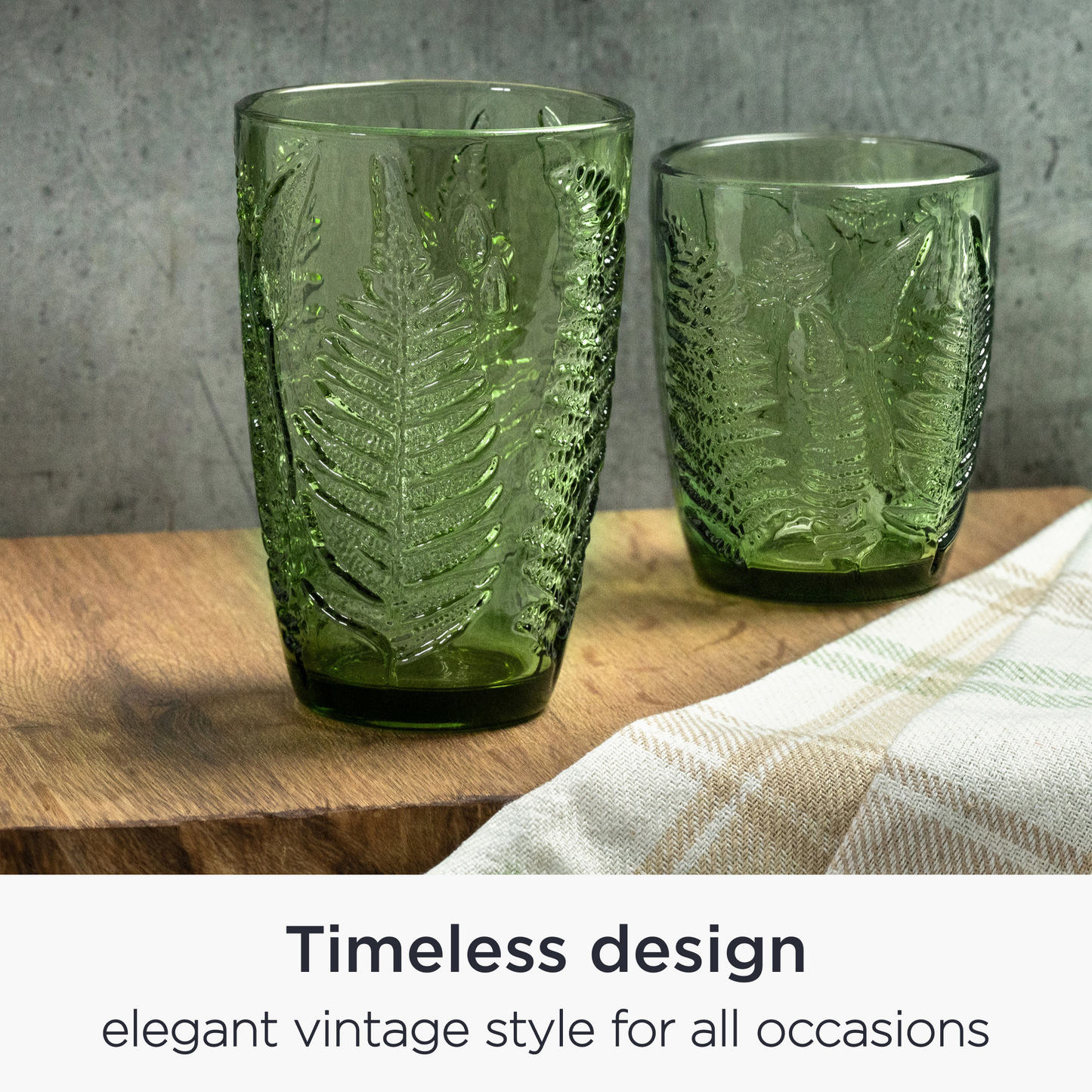 Vintage green glasses styled on a table with napkins and sunlight — elegant dining setup