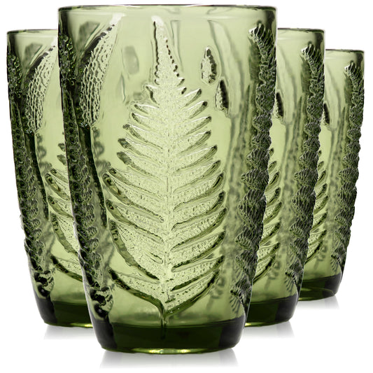 Set of four green vintage-style drinking glasses with embossed fern pattern on white background